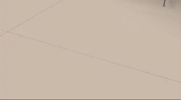 A large indoor swimming pool with a clear roof.