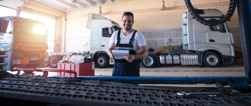 Mechanic Doing Maintenance Check on Truck Fleet