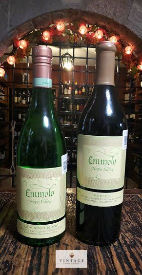 Dos botellas de vino están sobre una mesa de madera.