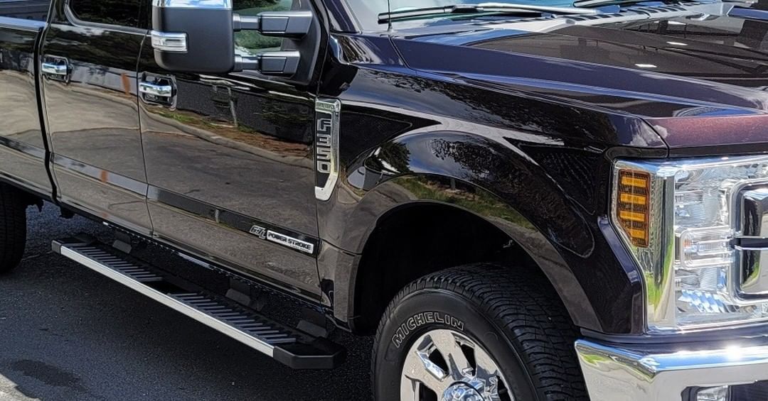 A black pickup truck is parked on the side of the road.