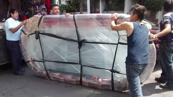 Dos hombres están cargando cajas en un camión de mudanzas.