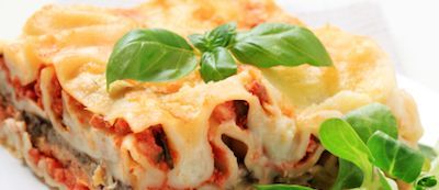 Lasagna with fresh basil garnish.