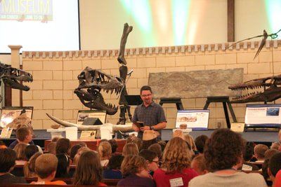 Matt teaching in front of dino skeletons