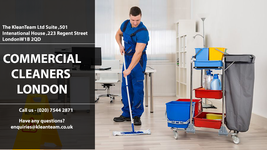 A man is mopping the floor in an office.