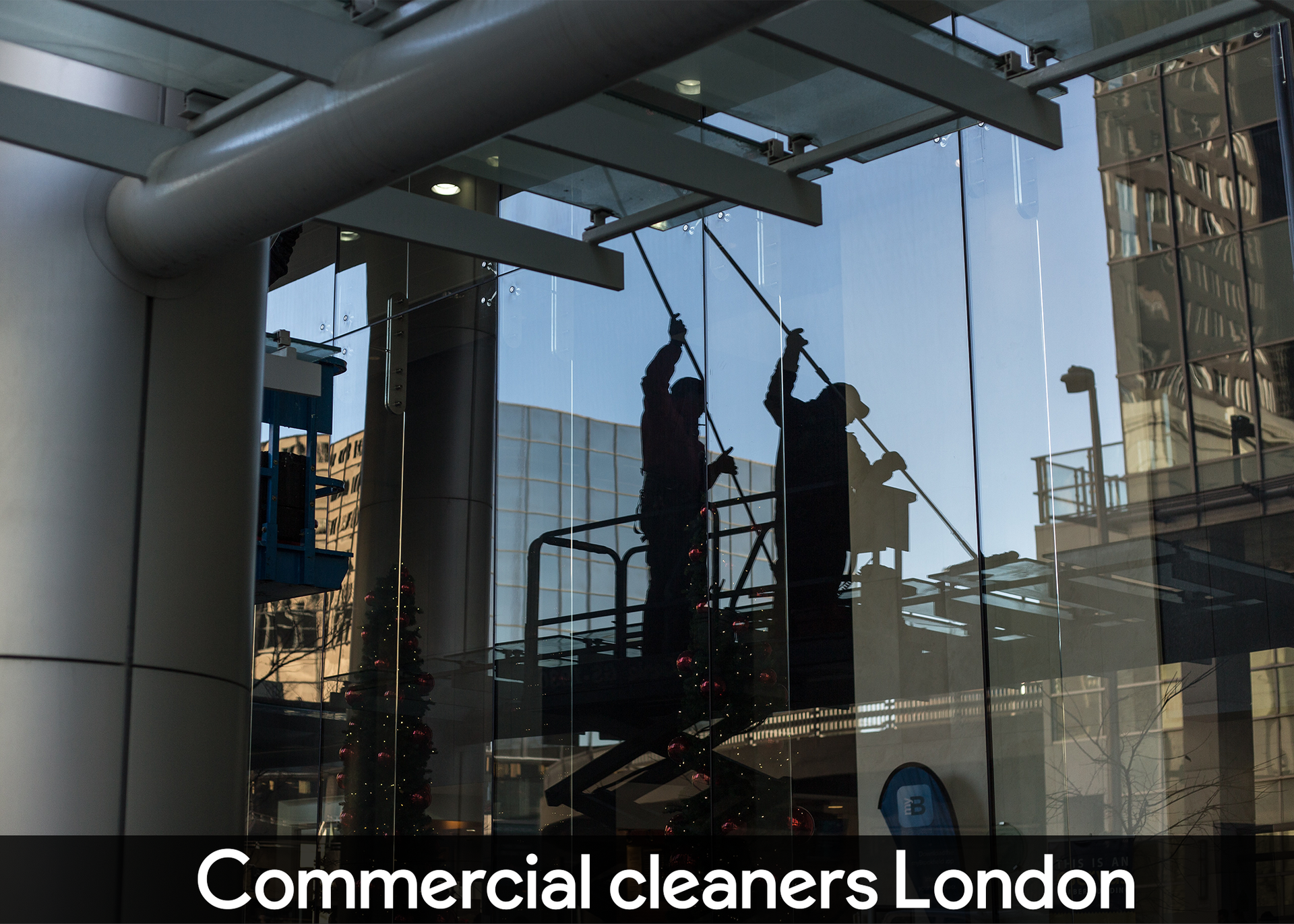 Two men are cleaning the windows of a building in london