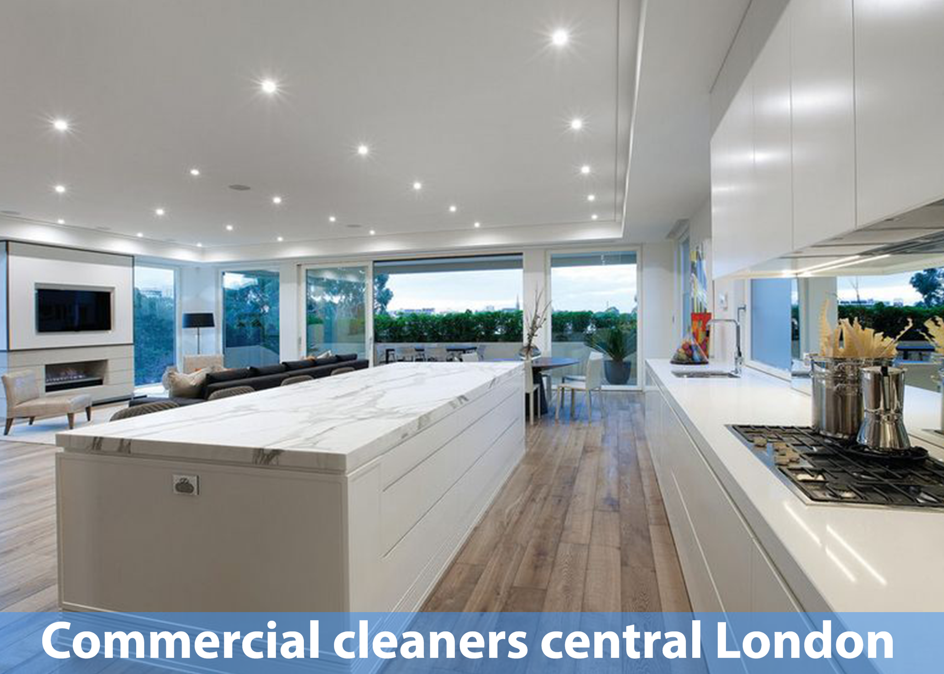 A kitchen with a large island in the middle and the words commercial cleaners central london on the bottom