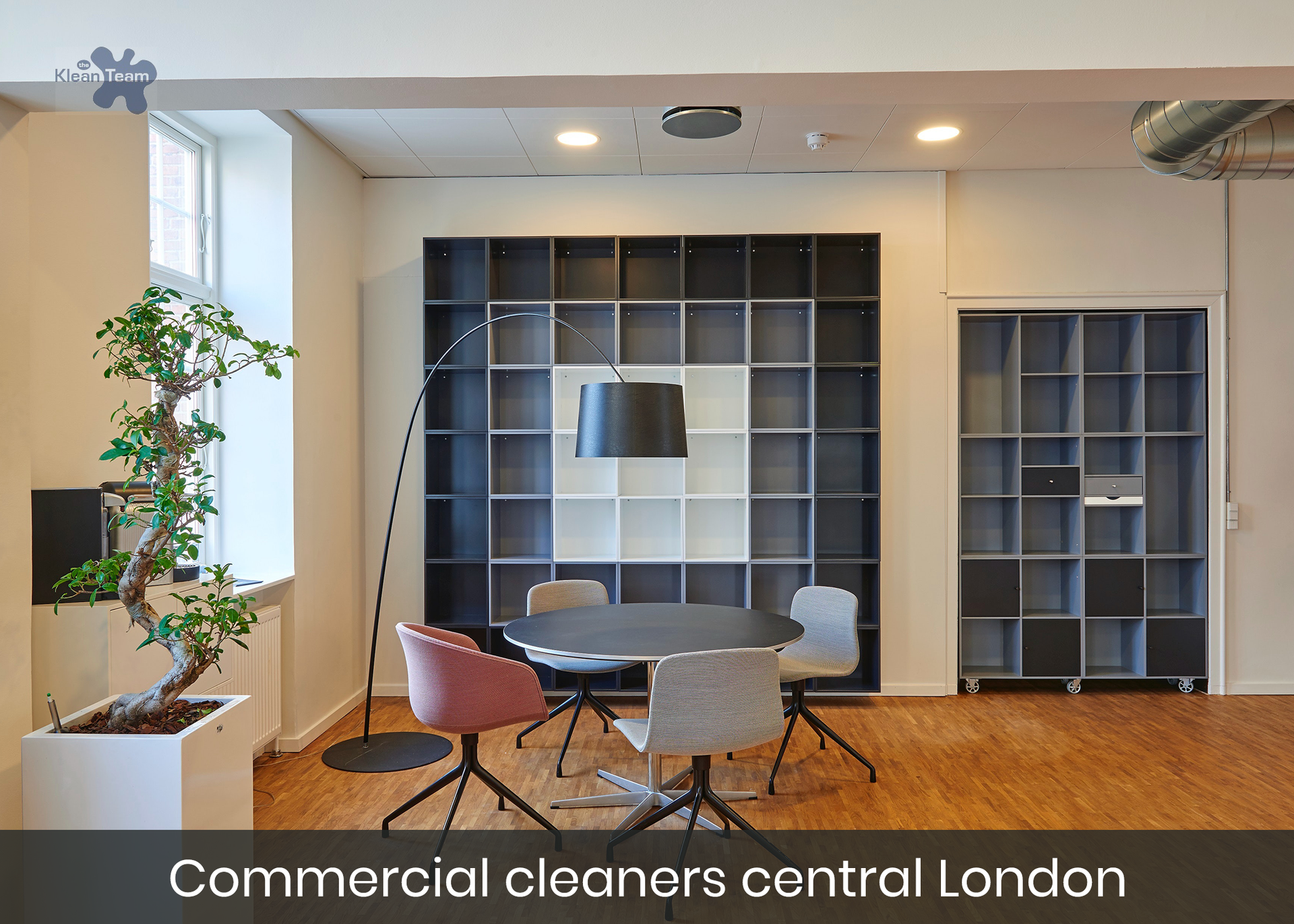 A room with a table and chairs and a sign that says commercial cleaners central london