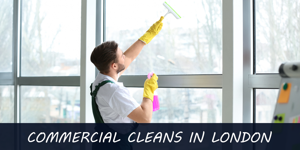 A man is cleaning a window with a squeegee in london.