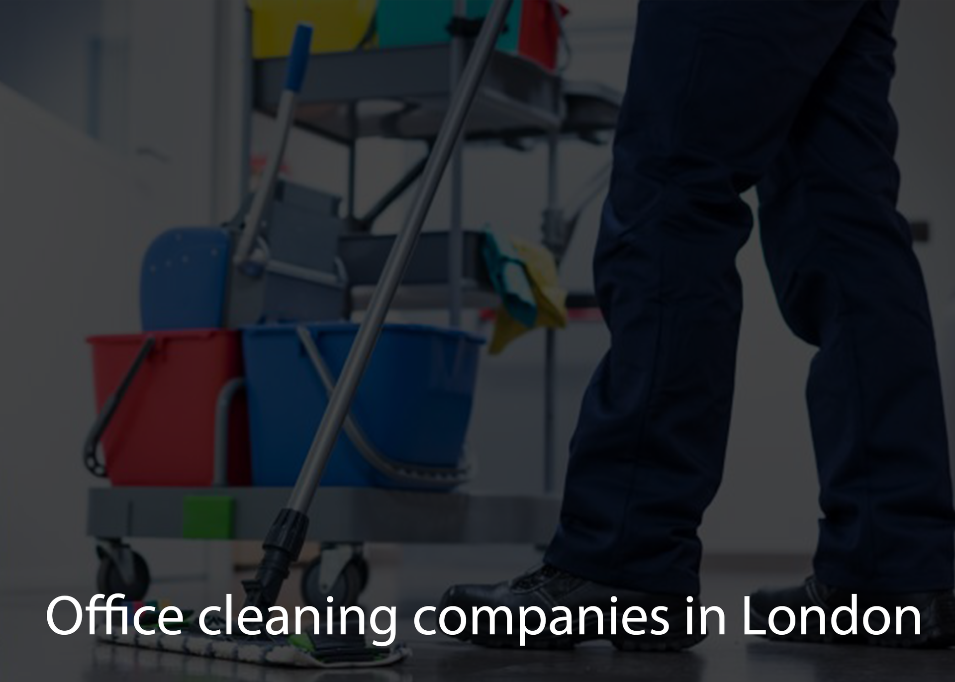 A person is cleaning an office with a mop and buckets.