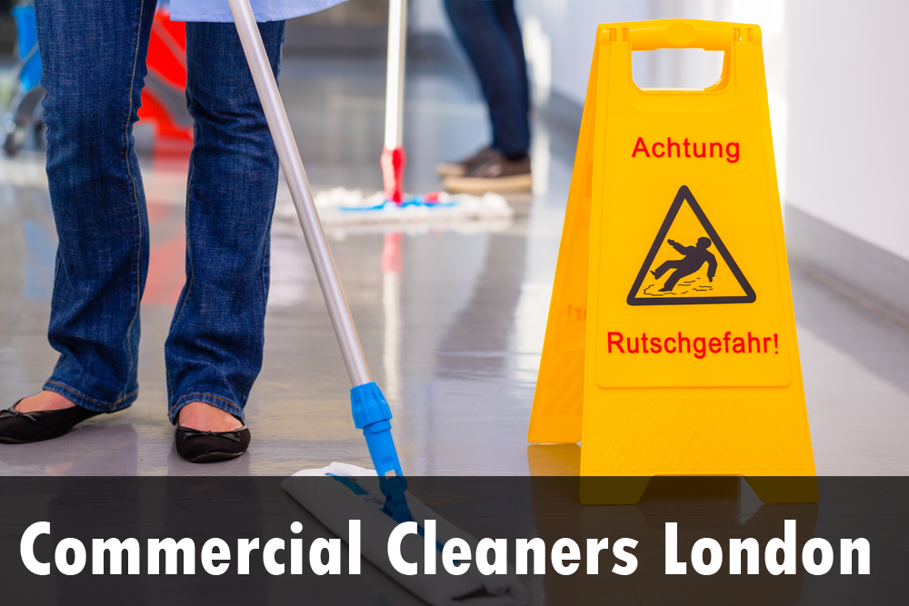 A woman is mopping the floor next to a caution sign.