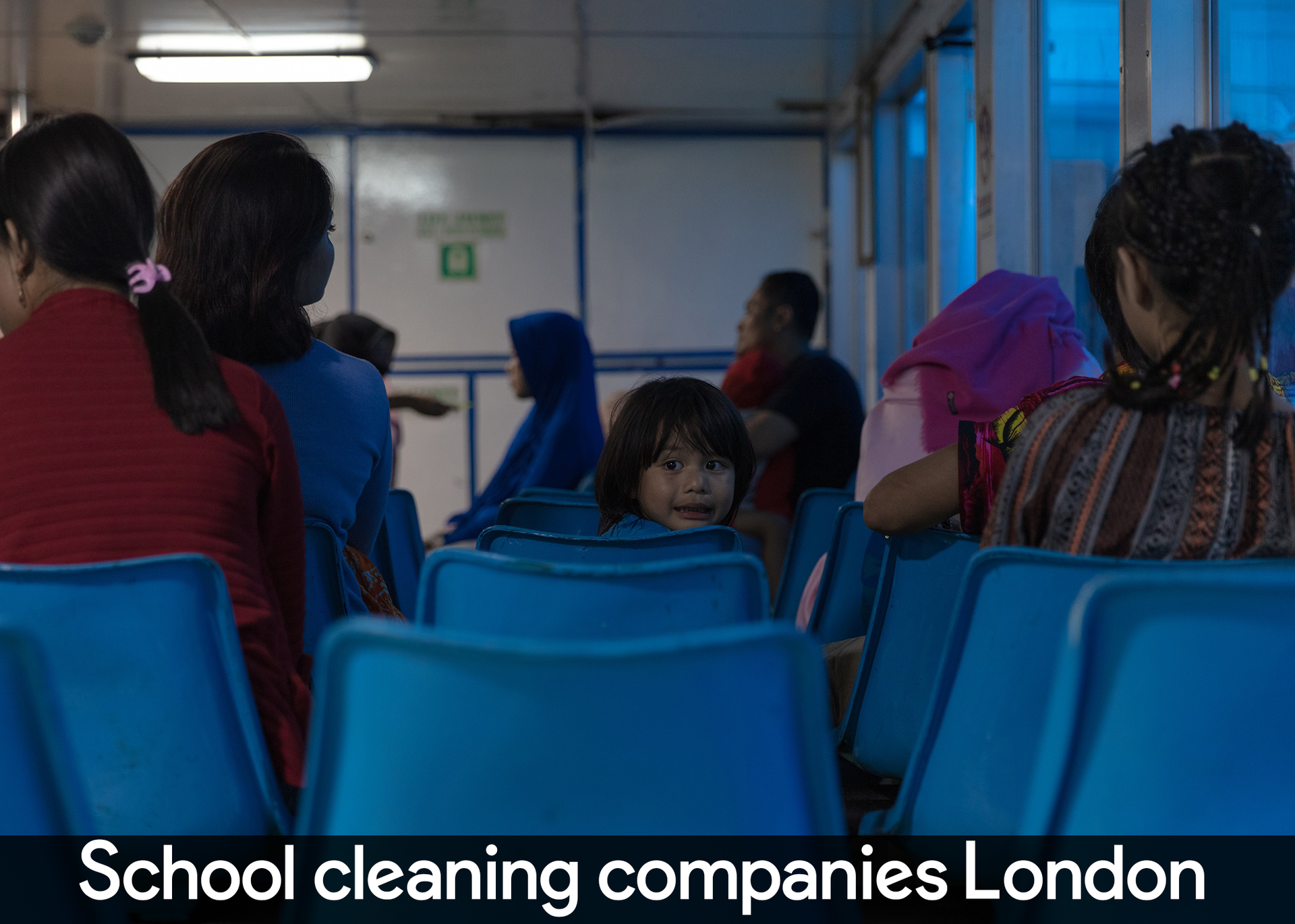 A group of people sitting in blue chairs with the words school cleaning companies london on the bottom