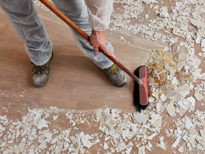 A person is sweeping the floor with a broom.