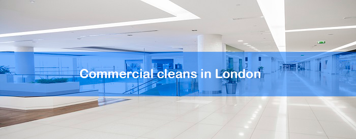 A blurred image of a building with a blue banner that says commercial cleans in london.