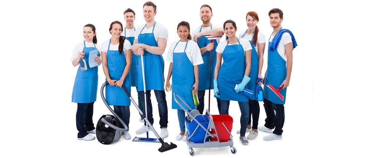 A group of cleaners are posing for a picture with cleaning supplies.