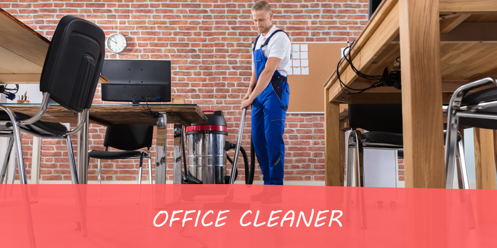 A man is cleaning an office with a vacuum cleaner.