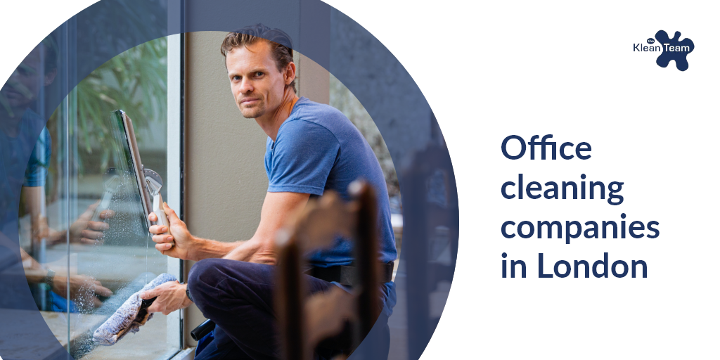 A man is cleaning a window with a vacuum cleaner.