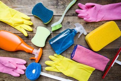 cleaning supplies on a wood background