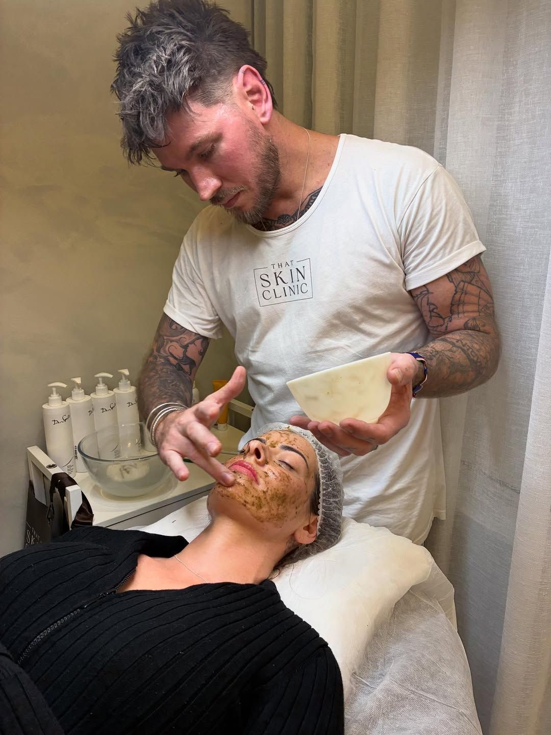 A Person in a White Shirt Applies a Facial Mask — That Skin Clinic in Mooloolaba, QLD