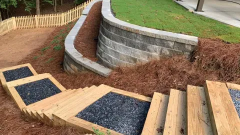 Newly poured concrete driveway with dividing lines, next to a lawn and house.