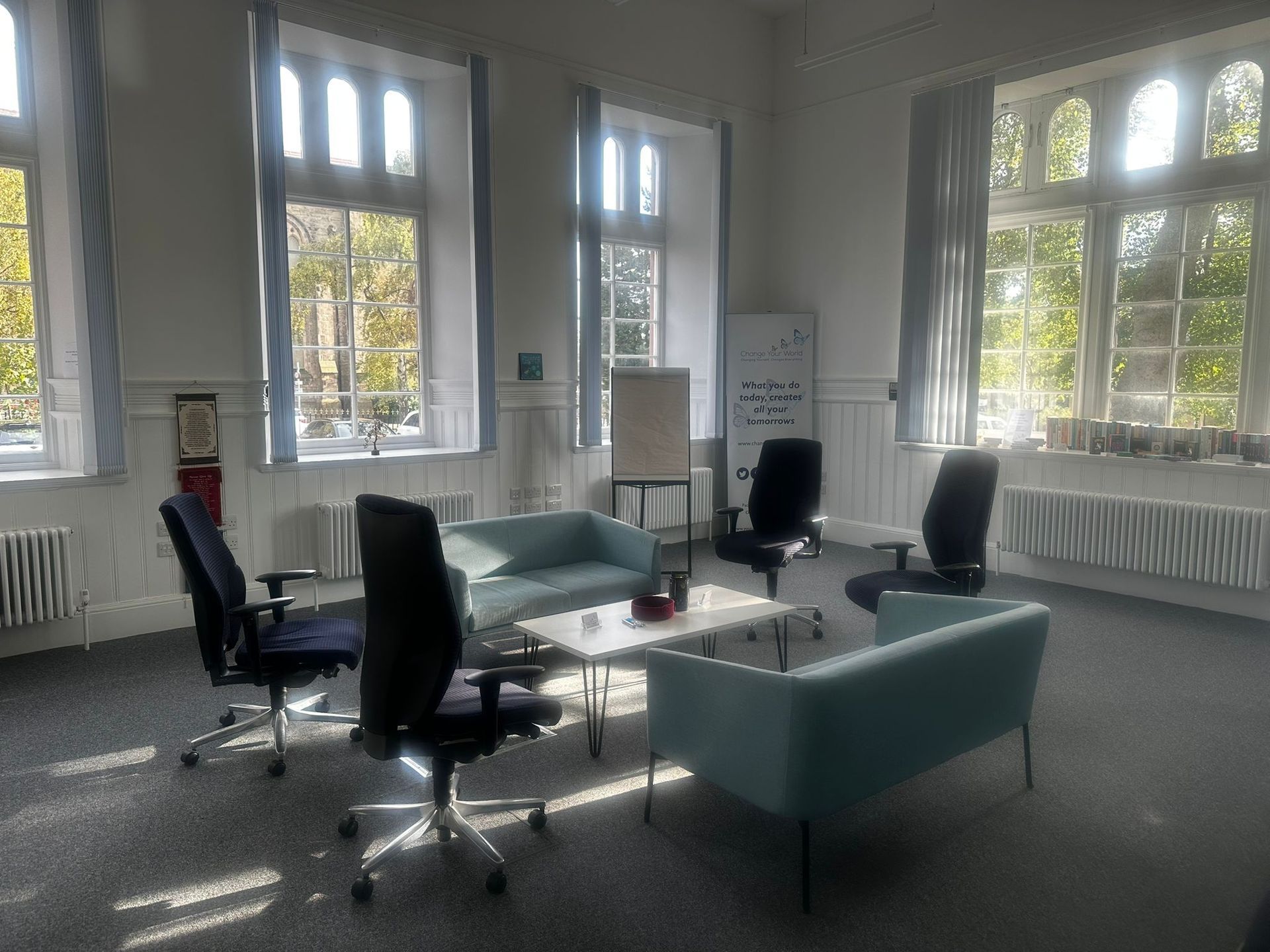 A light-filled room with two blue sofas,