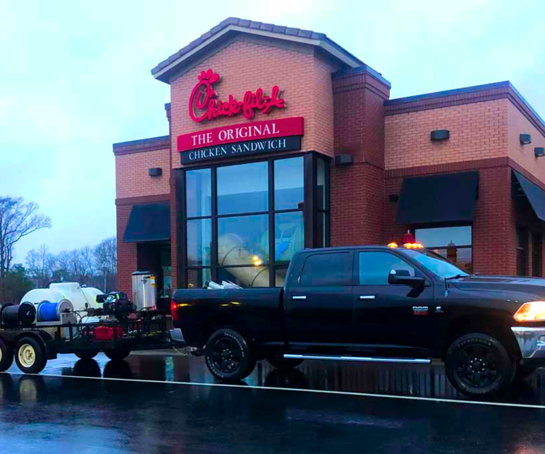 A truck is parked in front of a chick fil a restaurant