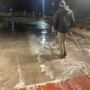 person pressure washing concrete in Elizabeth City, NC 