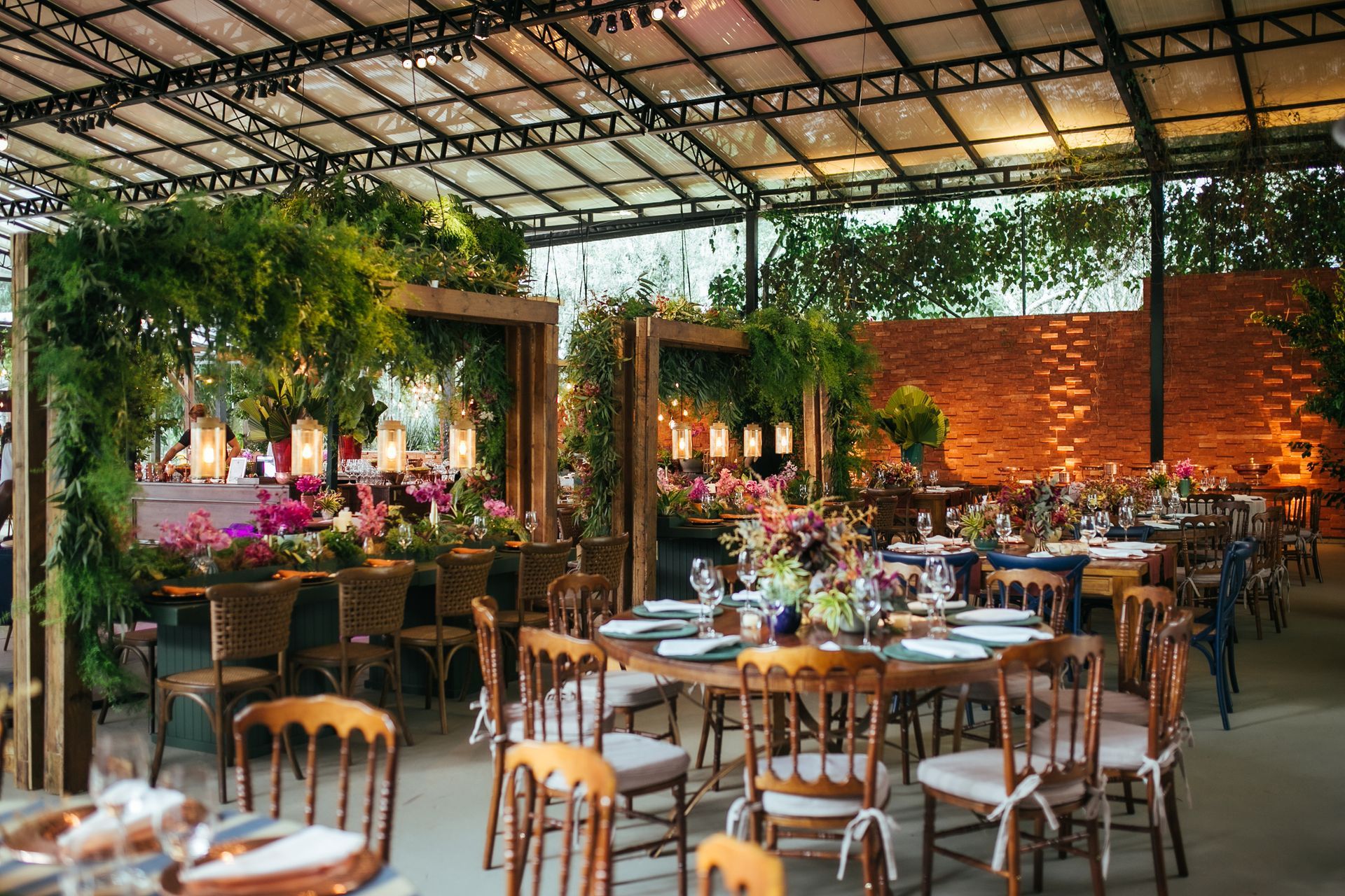 A large room with tables and chairs set up for a wedding reception.