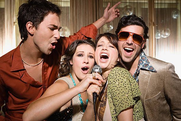 A dj is playing music in front of a crowd at a concert.