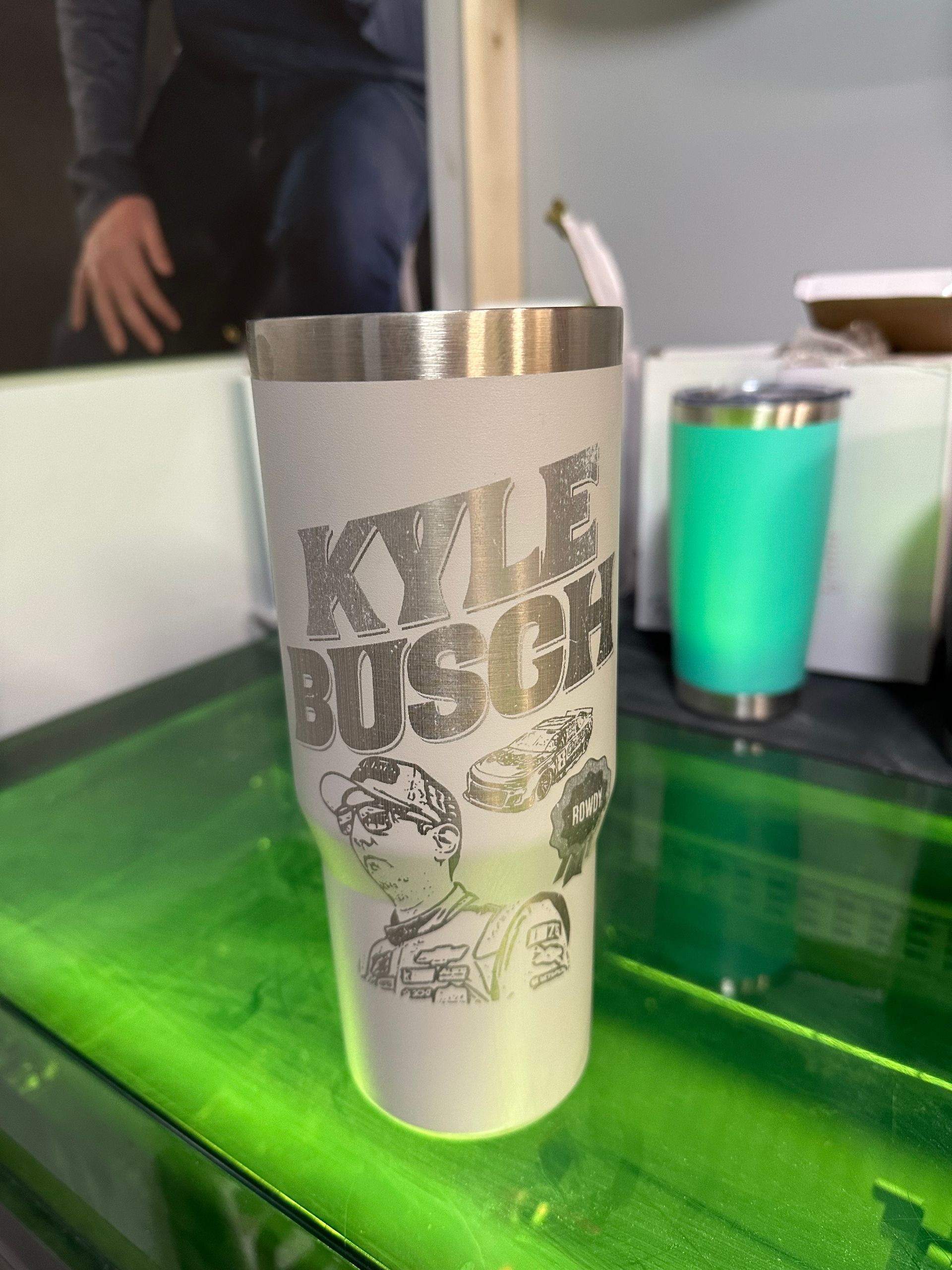 A kyle busch tumbler is sitting on top of a green table.