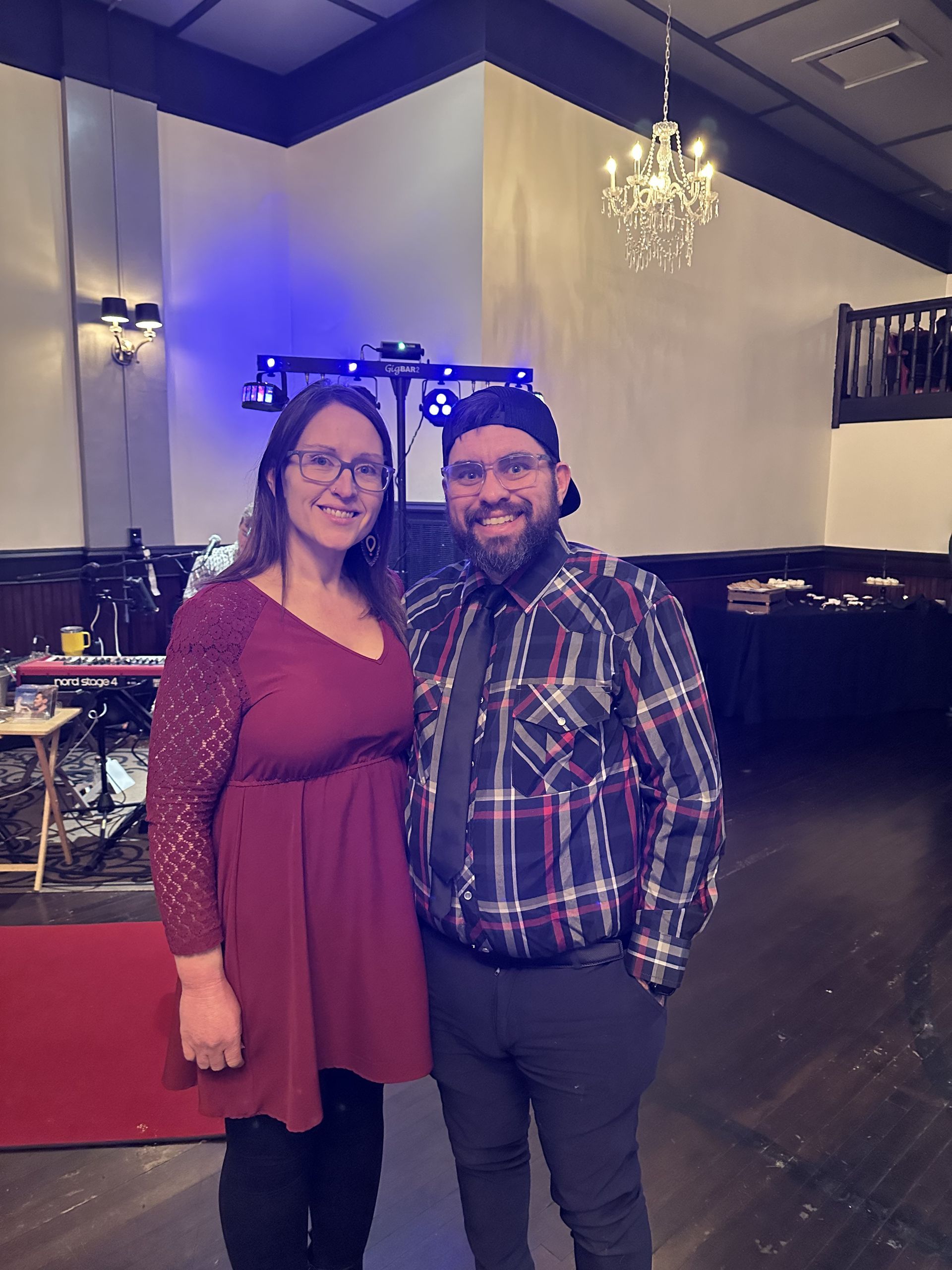 A man and a woman are posing for a picture in a room.