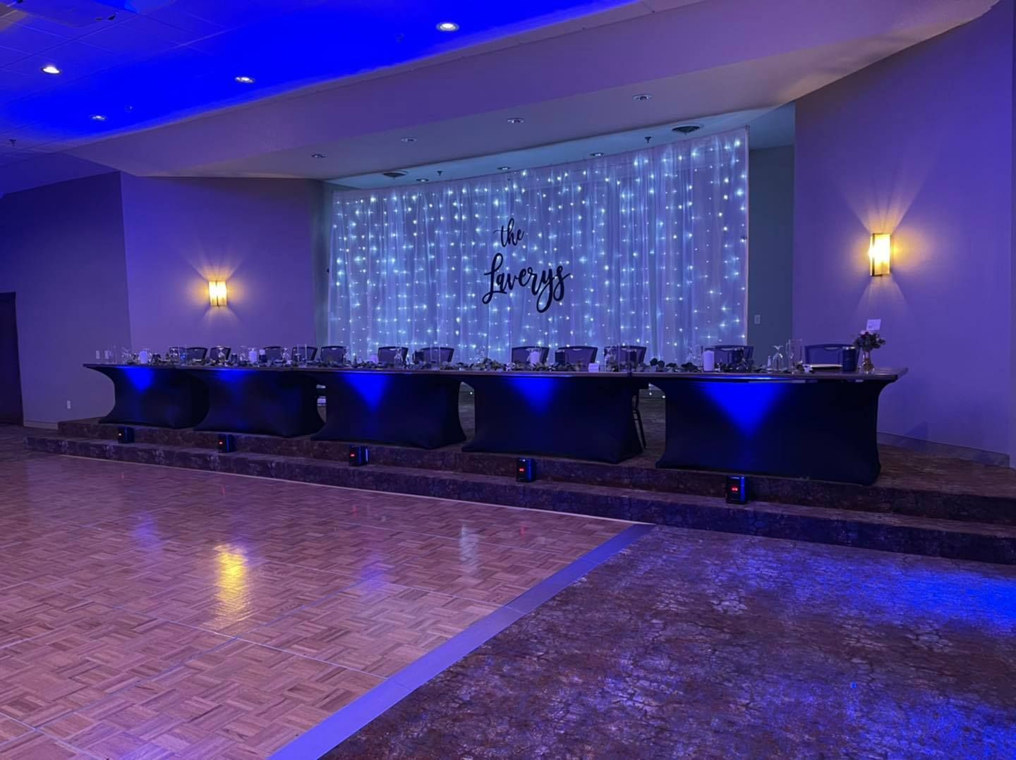 A long table in a room with blue lights on it.