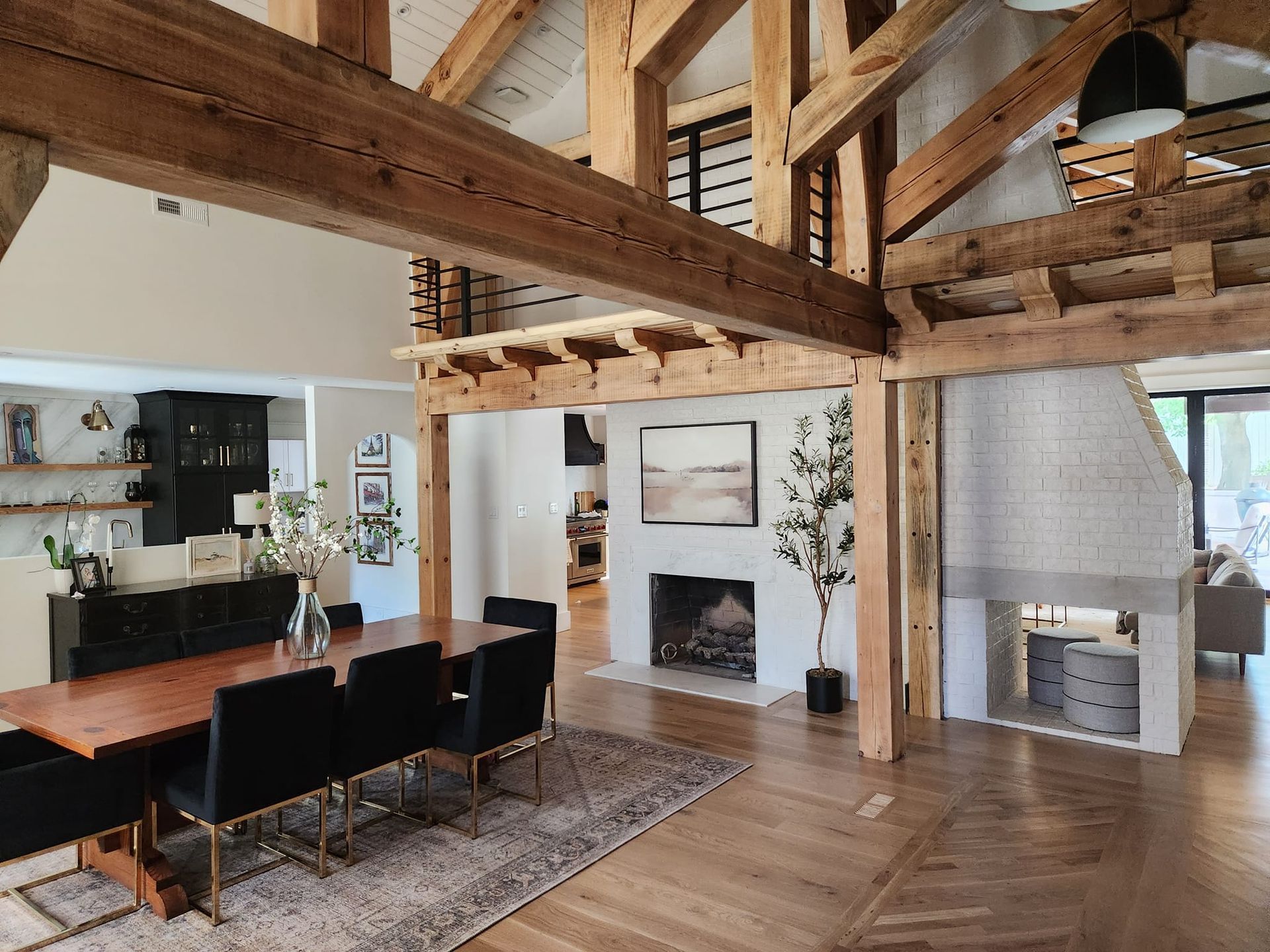 A large dining room with a wooden table and chairs and a fireplace.