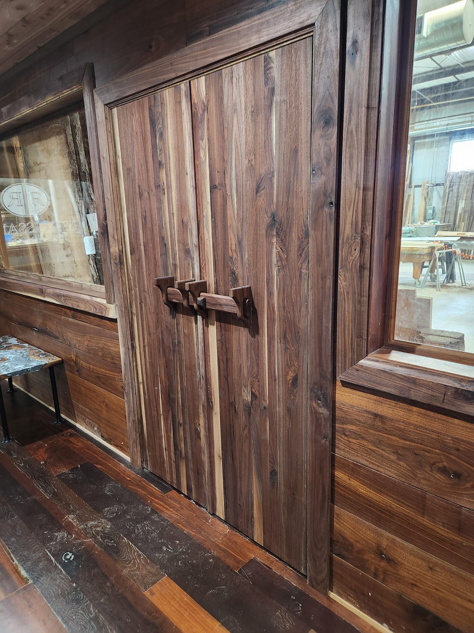 A wooden door is sitting in a room next to a window.