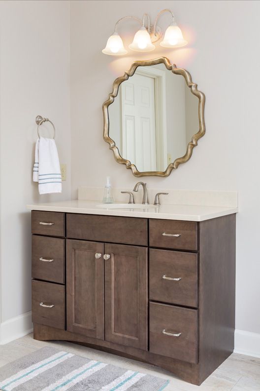 A bathroom vanity with a sink and a mirror