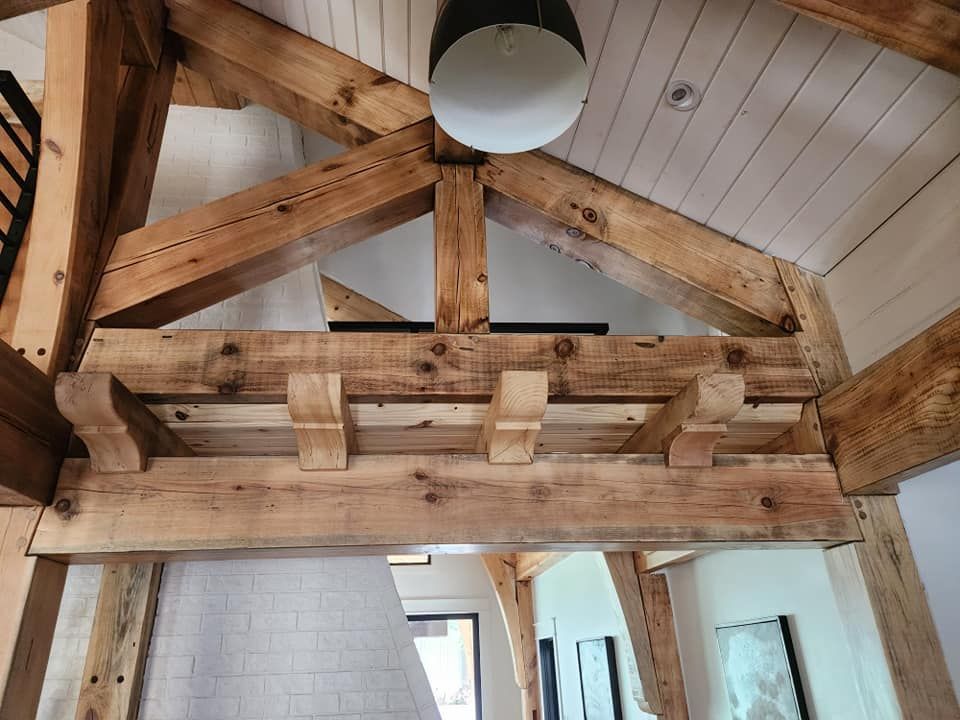 A wooden beam is hanging from the ceiling of a house.