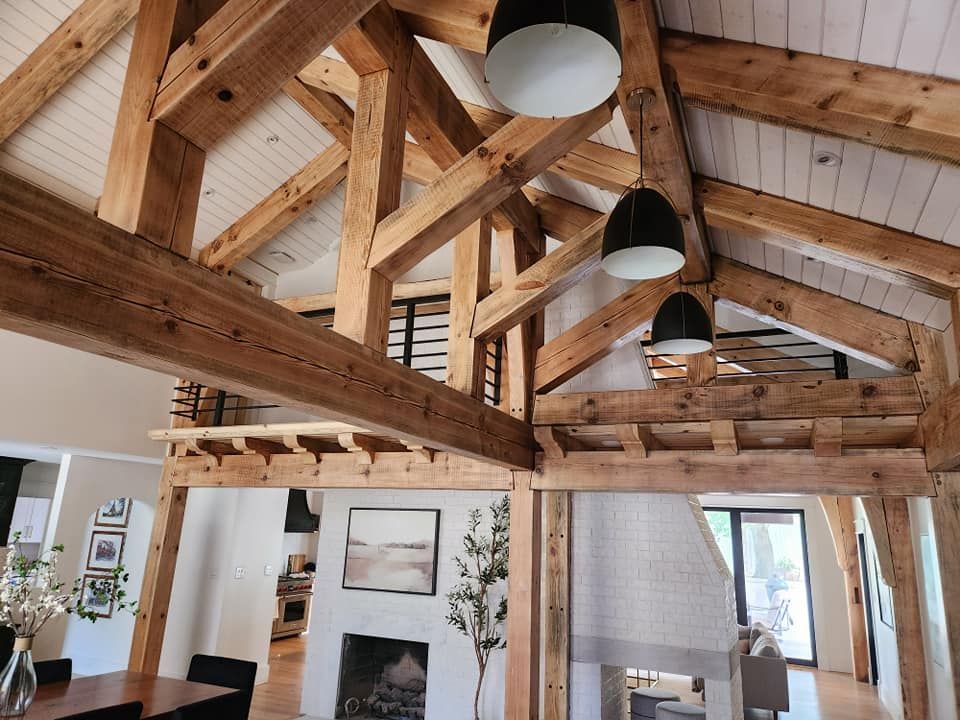 A living room with wooden beams and a fireplace