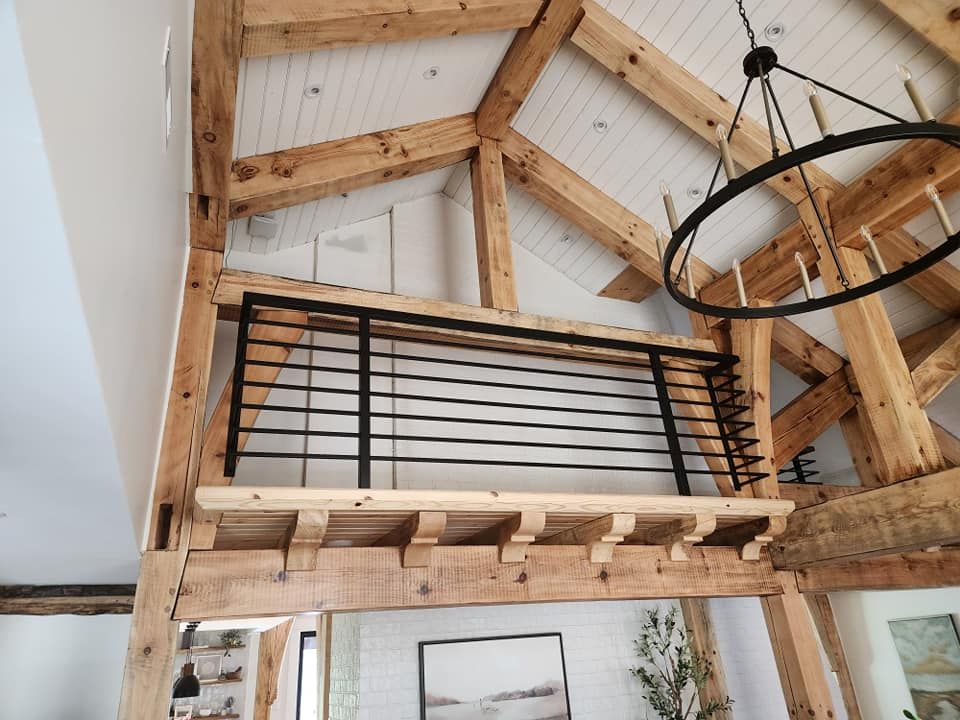 A wooden balcony with a metal railing in a house.