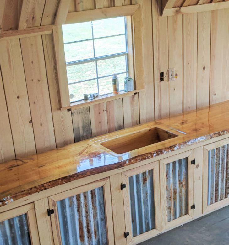 A kitchen with wooden cabinets and a sink