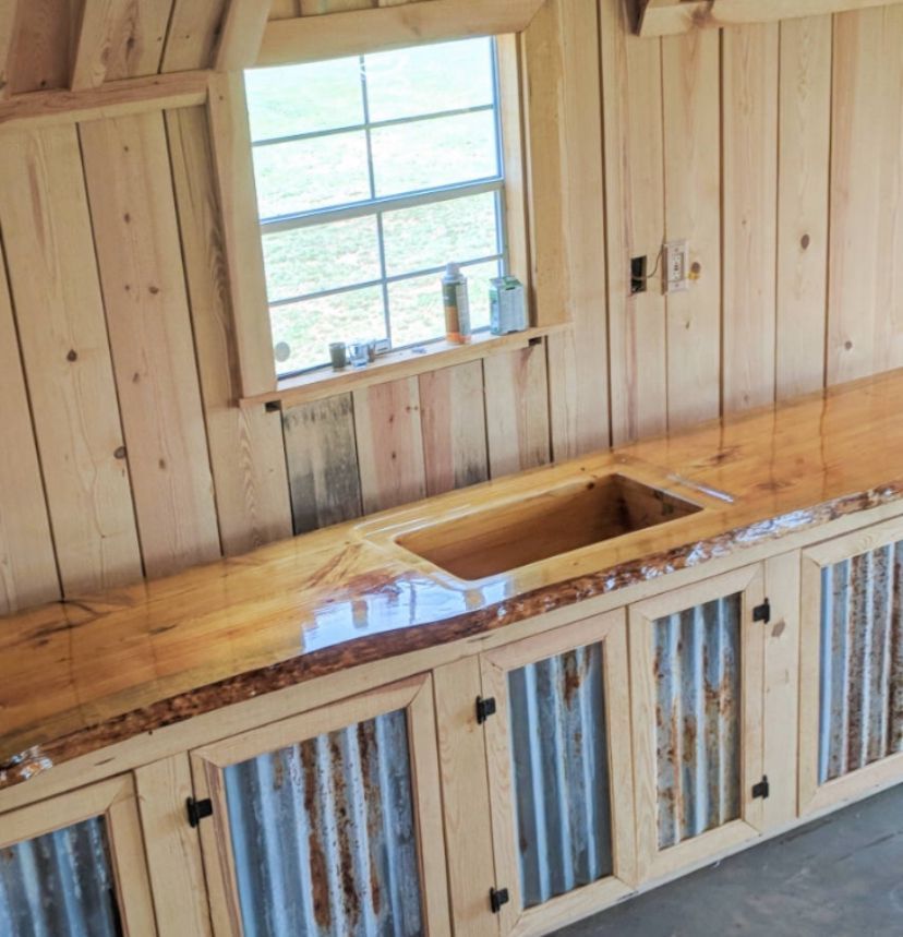 A kitchen with wooden cabinets and a sink