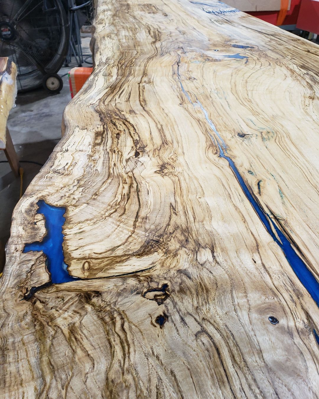 A piece of wood with a blue river in the middle of it.