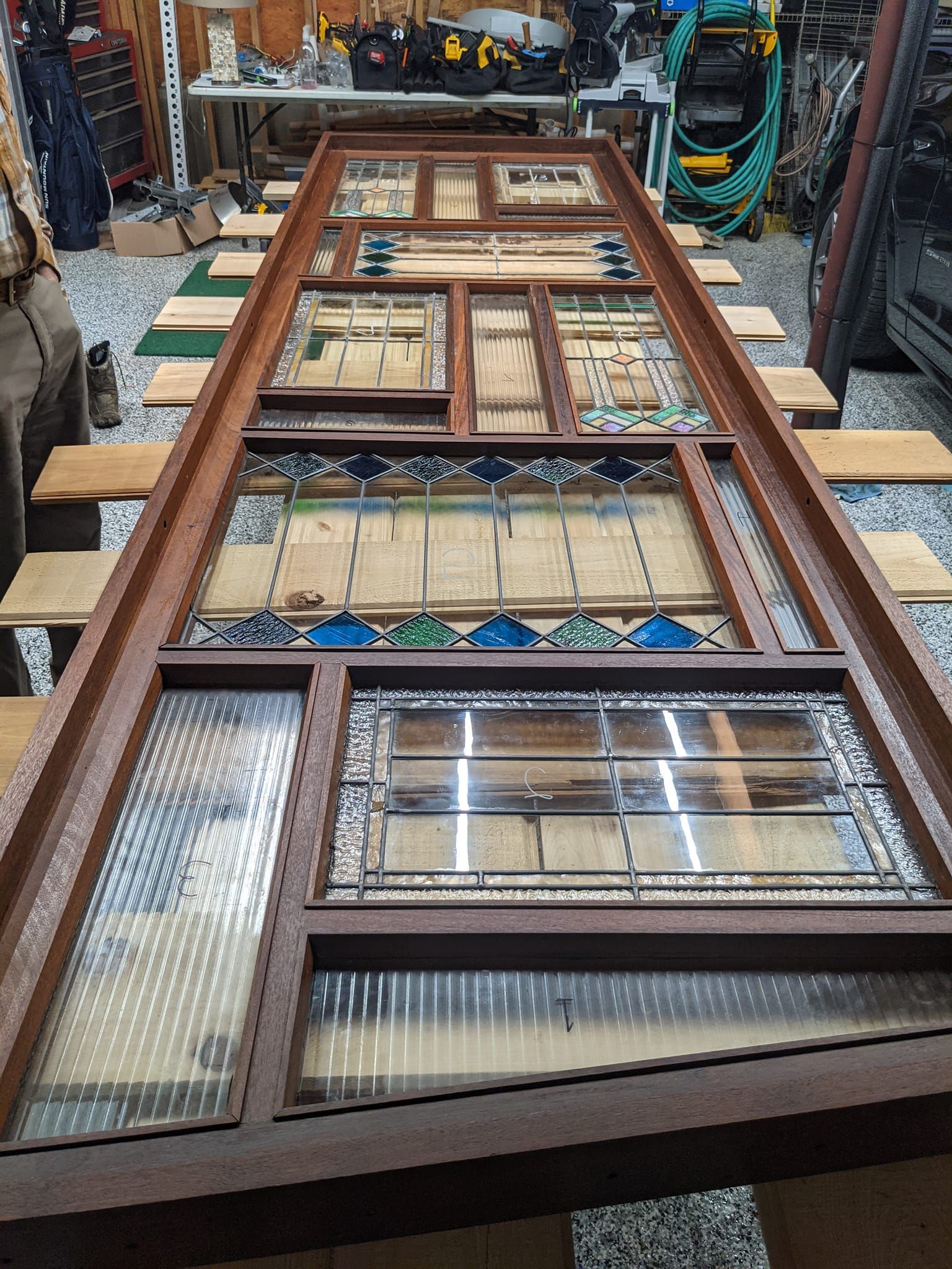 A wooden table with a lot of pieces of glass on it