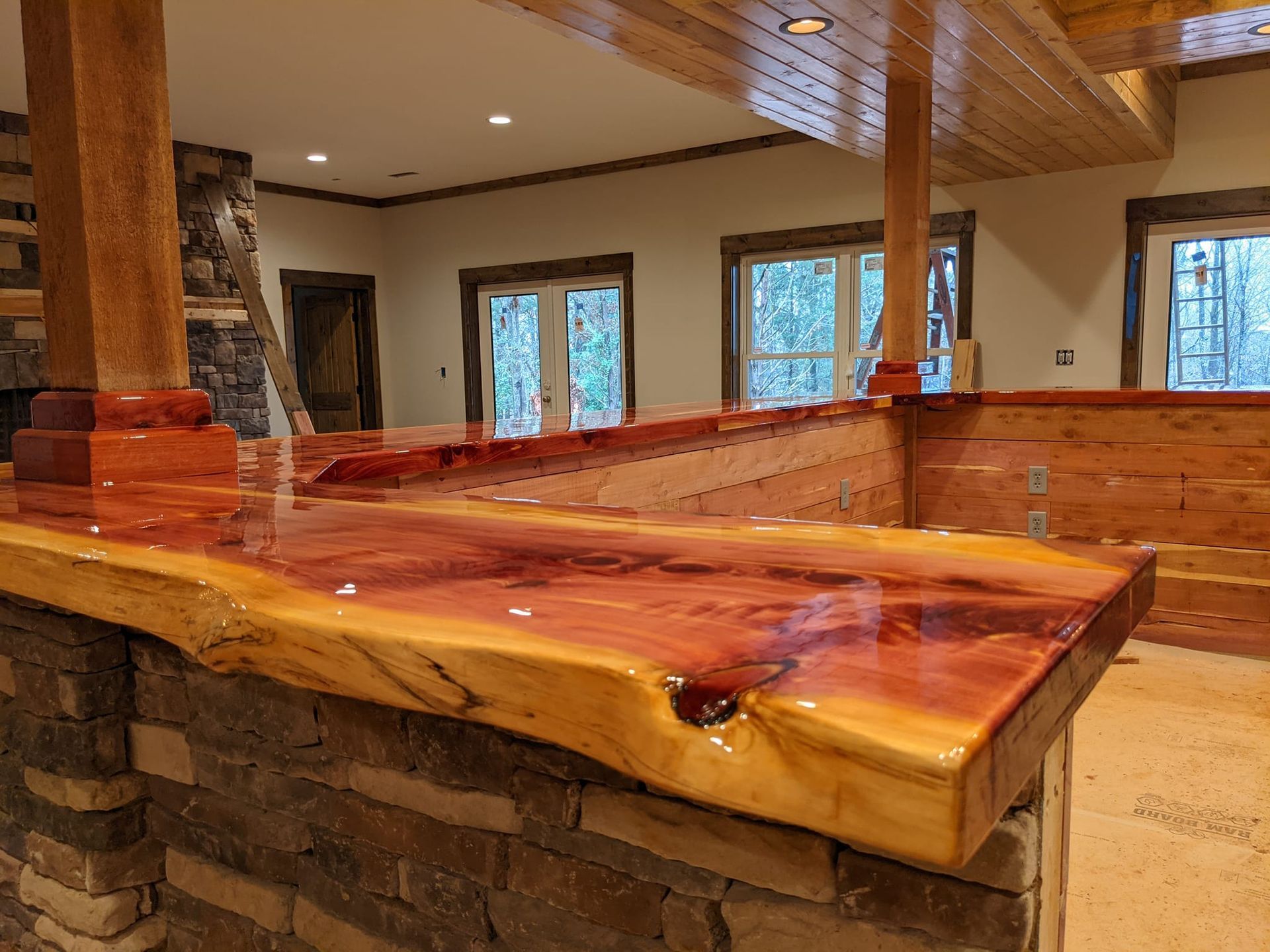 A wooden counter top in a room with a brick wall.