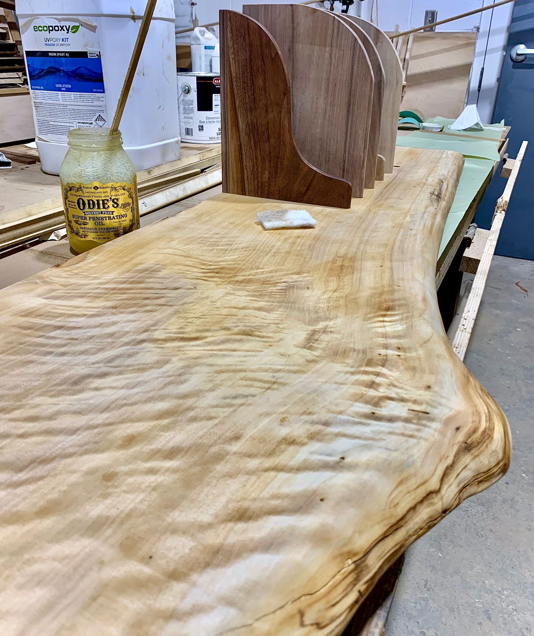 A wooden table with a bottle of honey on it.