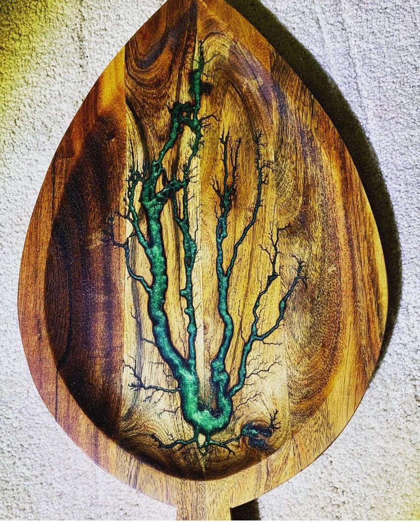 A wooden bowl with a tree design on it