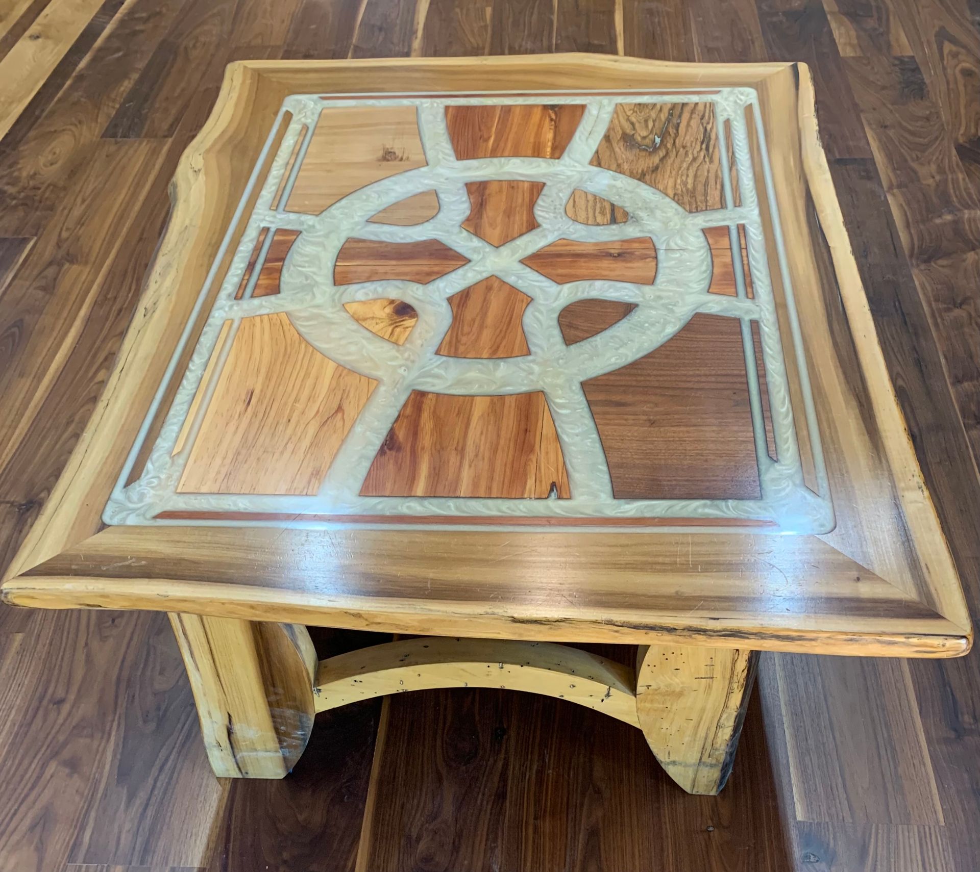A wooden table with a celtic design on it