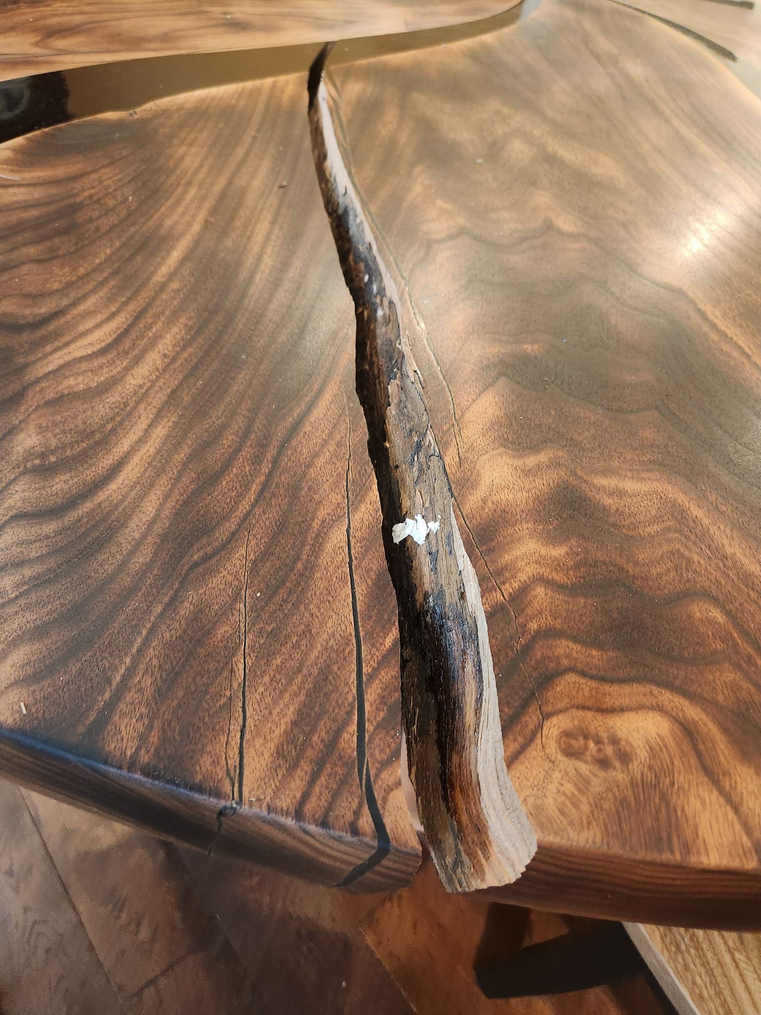 A piece of wood is sitting on top of a wooden table.