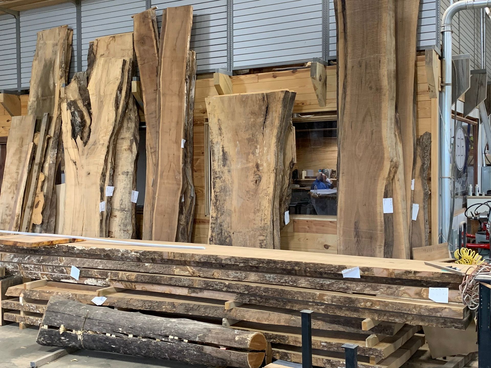 A warehouse filled with lots of logs and pieces of wood.