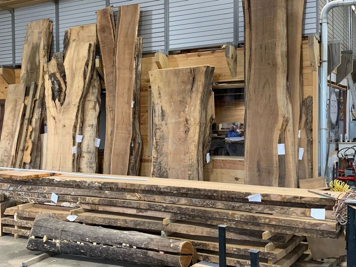 A warehouse filled with lots of logs and pieces of wood.