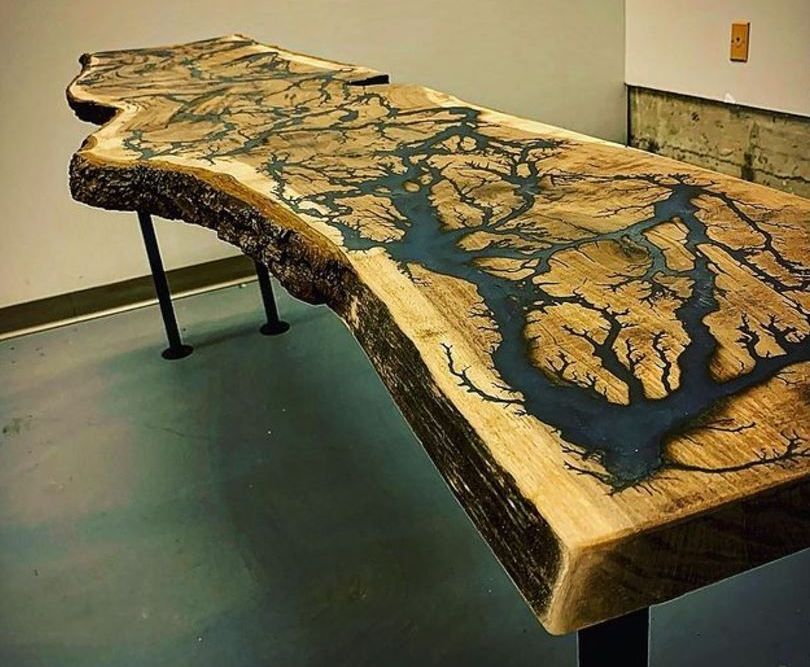 A wooden table with a river in the middle of it.