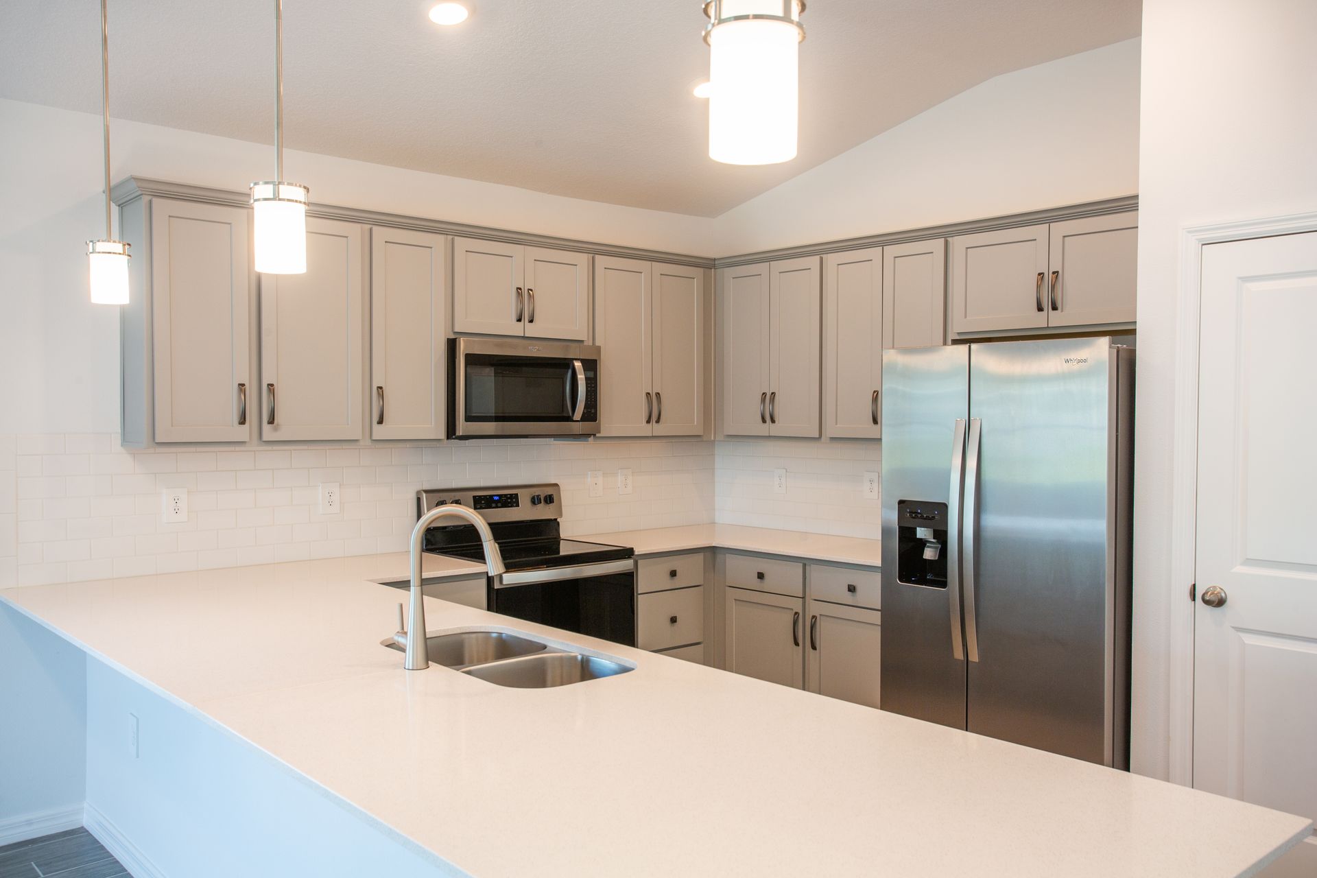 A kitchen with stainless steel appliances and white cabinets